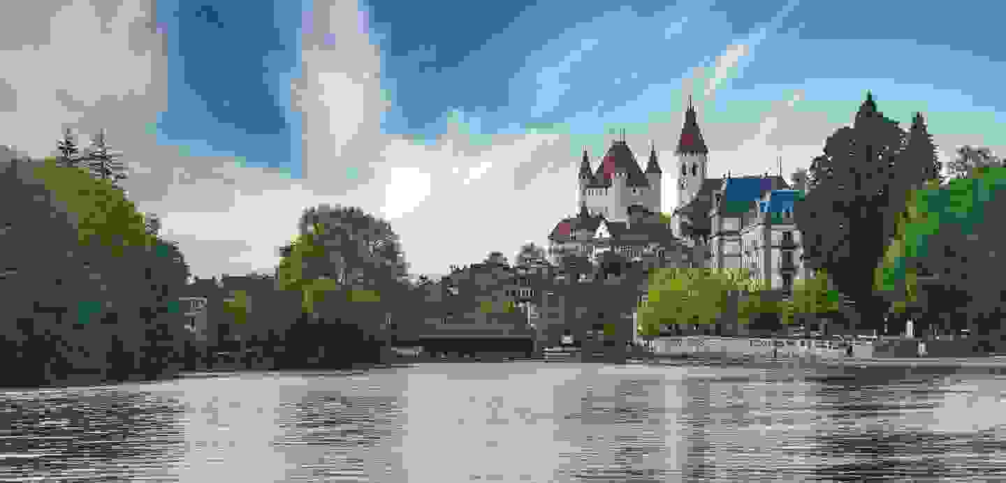 Stimmungsbild von Schloss Thun mit dem Thunersee im Vordergrund.
